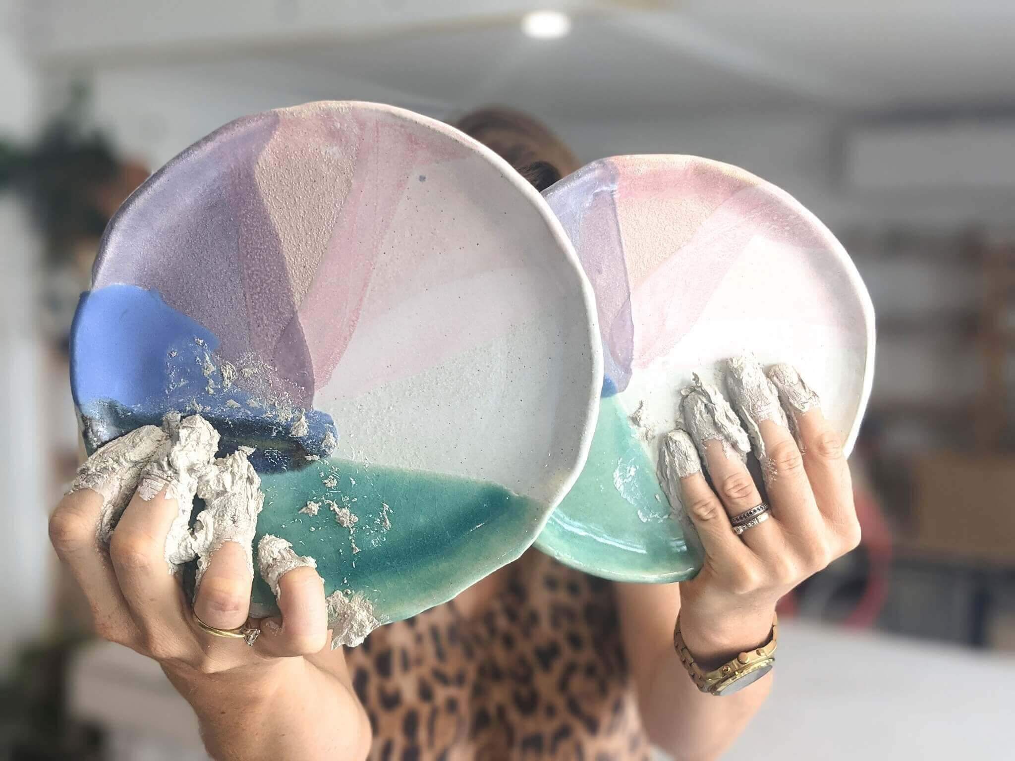 Two handcrafted clay plates ready for glazing